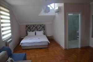 a bedroom with a bed and a walk in shower at Hotel Drina Premium in Sarajevo