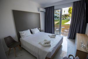 Postel nebo postele na pokoji v ubytování Olive Garden Hotel