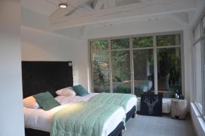 a bedroom with two beds and a large window at Domaine Shambala - gîte en Provence avec une Grande Piscine in Velaux +34 photos