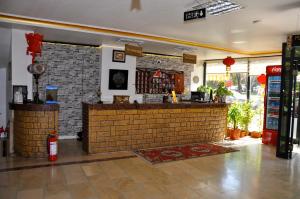 a bar in a restaurant with a brick wall at MEVLANA ŞEMS HOTEL in Konya