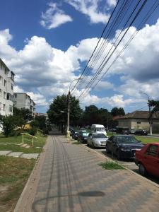 a person walking down a street with parked cars at Apartament Marian Mangalia in Mangalia