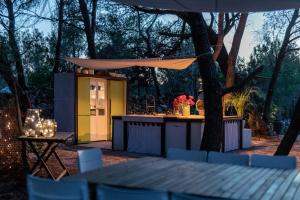 uma cozinha exterior com uma mesa e uma tenda em Plage Cachée - Glamping em Vrboska mais 37 fotografias