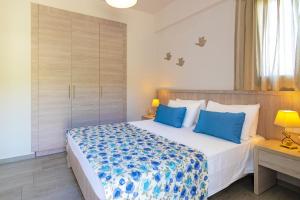 A bed or beds in a room at Evgoro Luxury Suites
