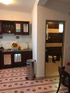 a kitchen with a trash can in the middle of a room at Sunset View Apartments in Bar +182 photos