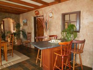 a kitchen with a island in a room with chairs at Sandalmere Cottage in Cadell