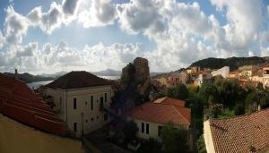 a view of a city with buildings and a cloudy sky at Calaluna in La Maddalena