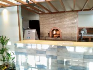 a kitchen with a brick oven in a room at Beit Alward in Ash Shafa