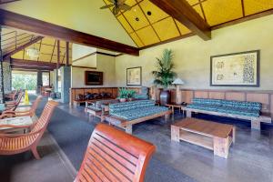 a large room with benches and tables and chairs at Aina Nalu in Lahaina