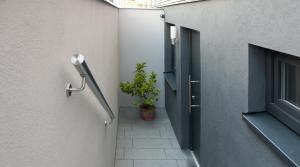 a hallway with a door and a potted plant at Ferienwohnung Mittelsberg in Konstanz +2 photos