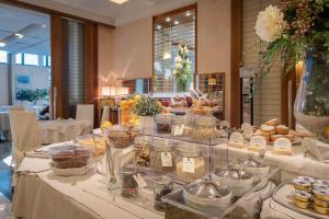 a buffet of food on tables in a restaurant at Hotel Polo in Rimini