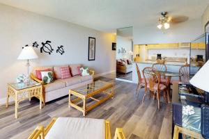 a living room with a couch and a table at Kahana Reef Oceanfront Condos in Kahana