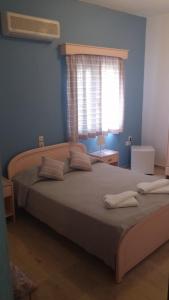 Postel nebo postele na pokoji v ubytování Ifigenia Hotel