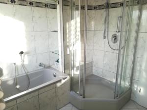 een badkamer met een douche en een bad bij Ferienwohnung Seeblick in Überlingen