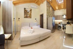 1 dormitorio con 1 cama blanca y cocina en Villa Rospovi, en Kaligata