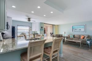 a kitchen and living room with a table and chairs at Riverside Club in Marco Island