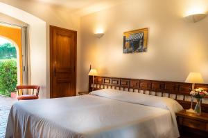 a bedroom with a large bed and a window at Hotel La Romarine in Saint-Tropez