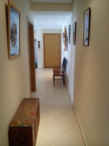 a hallway with a table and a chair in a room at location de vacance assilah marina golf in Asilah