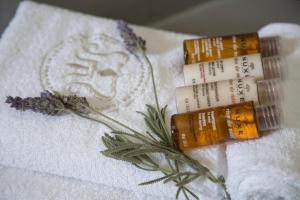 two tubes ofodorizers sitting on a white towel at Poseidon of Paros Hotel & Spa in Chrissi Akti