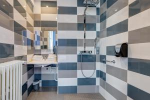 a bathroom with a shower and a sink at le paris brest hotel in Rennes