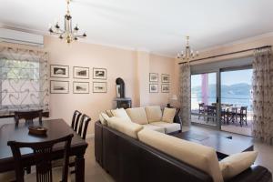 a living room with a couch and a table at Villa Soumela in Nikiana