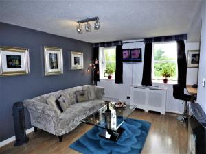 a living room with a couch and a table at Grassmarket Studio in Edinburgh