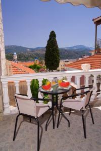 a table and chairs on a balcony with a view at Kefalos Quiet Apartment In Argostoli in Argostoli