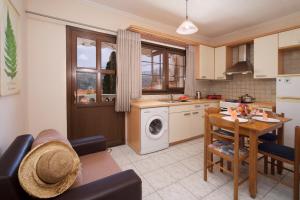 a kitchen and living room with a table and a dining room at Kefalos Quiet Apartment In Argostoli in Argostoli