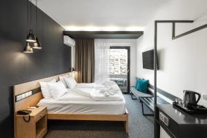
a bedroom with a large bed and a large window at Park Hotel in Thessaloniki
