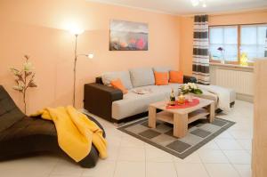 a living room with a couch and a table at Ferienwohnungen Renner in Viereth-Trunstadt