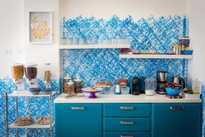 a blue and white kitchen with blue wallpaper at Colors B&B in Palermo
