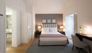 a hotel room with a bed and a desk and a bedroom at Grape Harbor Prata Apartments in Lisbon