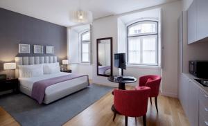a hotel room with a large bed and a large window at Grape Harbor Prata Apartments in Lisbon