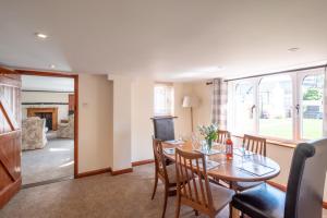 a dining room with a table and chairs at 3 Beach Cottages - Aldeburgh Coastal Cottages in Thorpeness