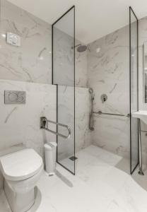 
a bathroom with a toilet, sink and shower at Park Hotel in Thessaloniki
