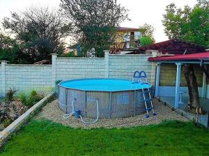 a swimming pool in a yard next to a fence at Villa Maja in Varna City