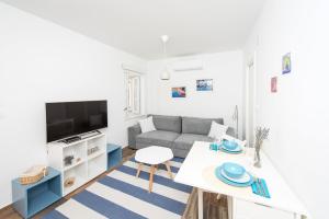 uma sala de estar com um sofá e uma mesa em Yacht harbor apartment em Hvar