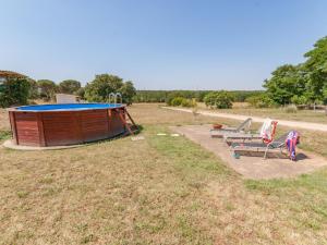 a group of chairs and a gazebo in a field at Belvilla by OYO Pahissa Can Abres in Cassà de la Selva