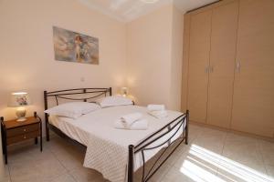 a bedroom with a bed with white towels on it at "Hermes" central apartment in Argostoli