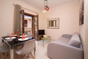 a living room with a table and a couch at Apollon Apartment In Argostoli in Argostoli