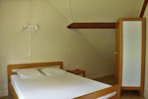 a bed with two pillows on it in a room at Camping Le Païsserou in Najac