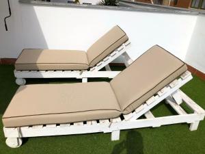 a couple of chairs sitting on top of grass at SevillaHome - Marqu&eacute;s de Paradas in Seville