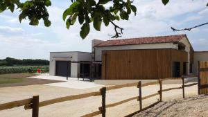 a building with a fence in front of it at La Ry'Bambelle in Les Herbiers