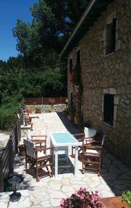 a patio with a table and chairs and a building at Gianna's Villa in Alexandros