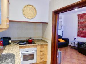 a kitchen with a counter and a living room at Kasa Sunshine in Olhão +54 photos