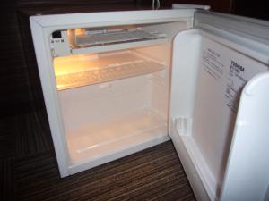 an empty refrigerator with its door open in a room at Hotel Crown Hills Nakamura in Shimanto