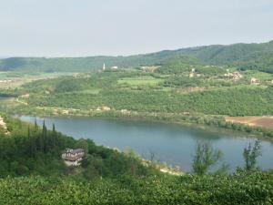 a view of a river with a house on a hill at Bed and Breakfast La Quiete in Arcugnano
