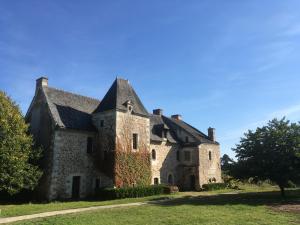 an old stone house on a green lawn at Manoir de Jouralem in Blaison