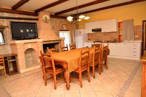 a dining room with a table and a fireplace at Alloggio nonna Cornelia in Citta' Sant'Angelo