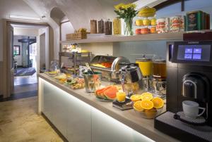 a breakfast counter with fruits and juice on it at Clementin in Prague