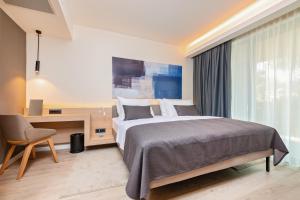 Postel nebo postele na pokoji v ubytování Garden Suites Park Plava Laguna